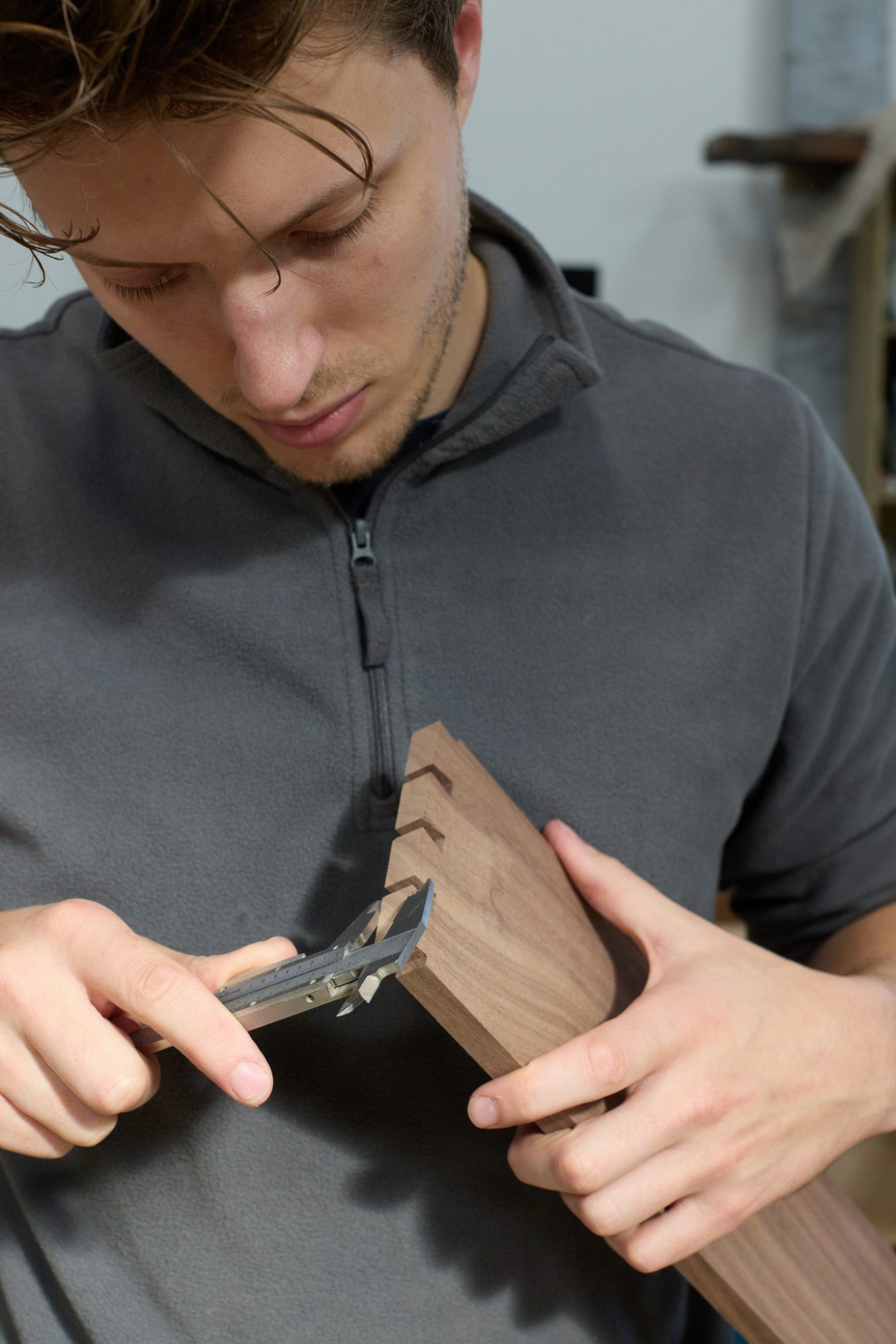 Measuring a dovetail joint with calipers
