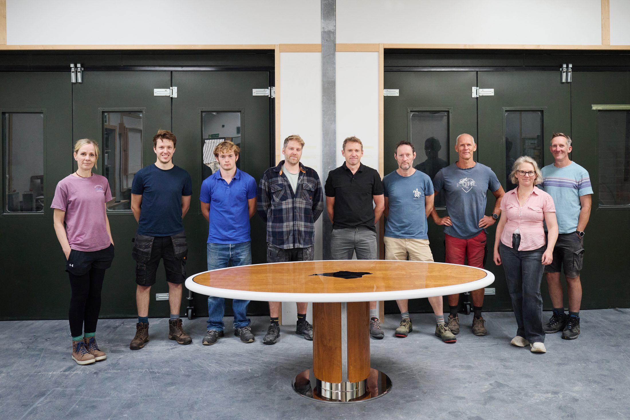 The Jonathan Rose Fine Furniture team with a finished oval dining table