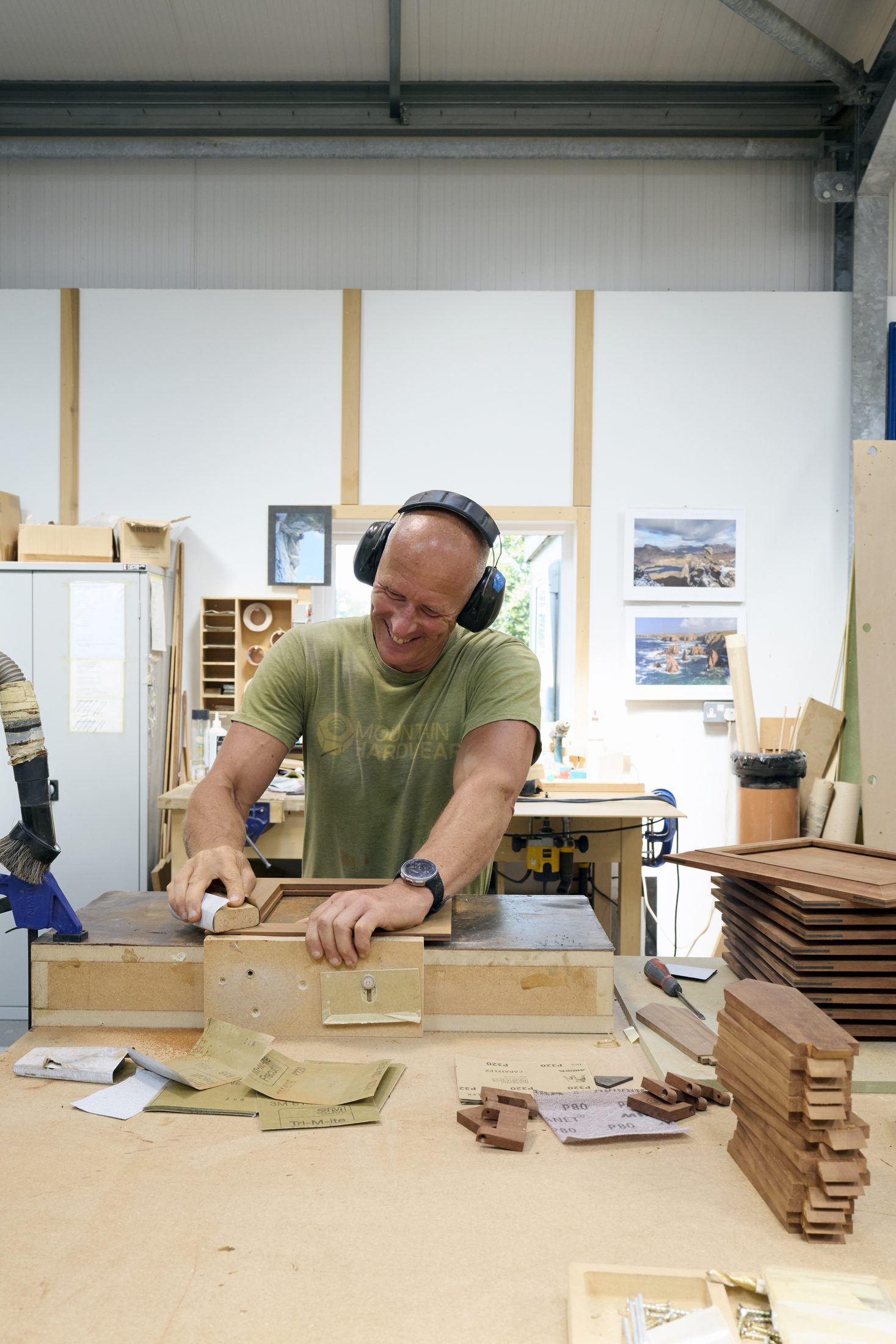 Sanding a drawer front in the workshop