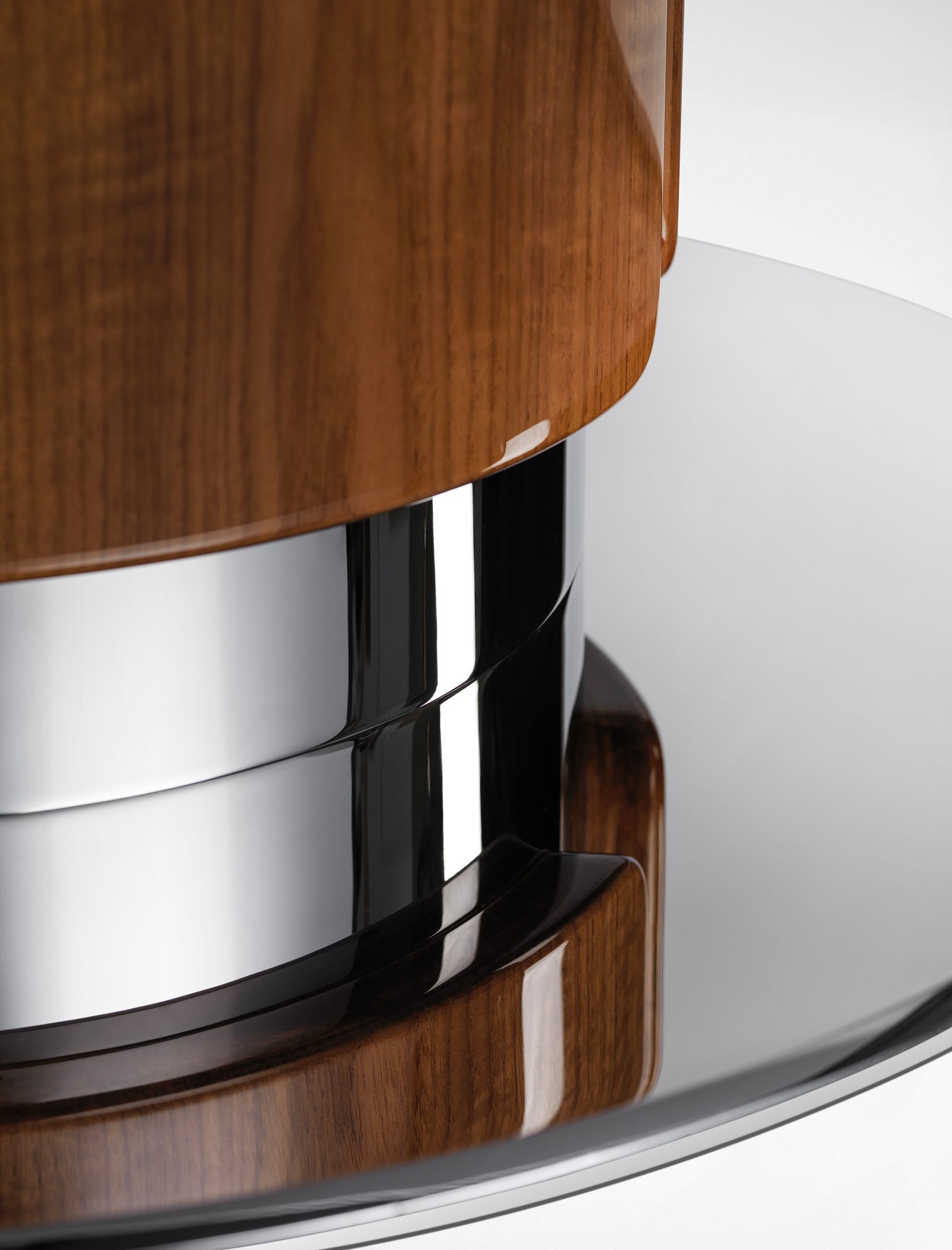 Detail of the teak and polished stainless-steel pedestal base