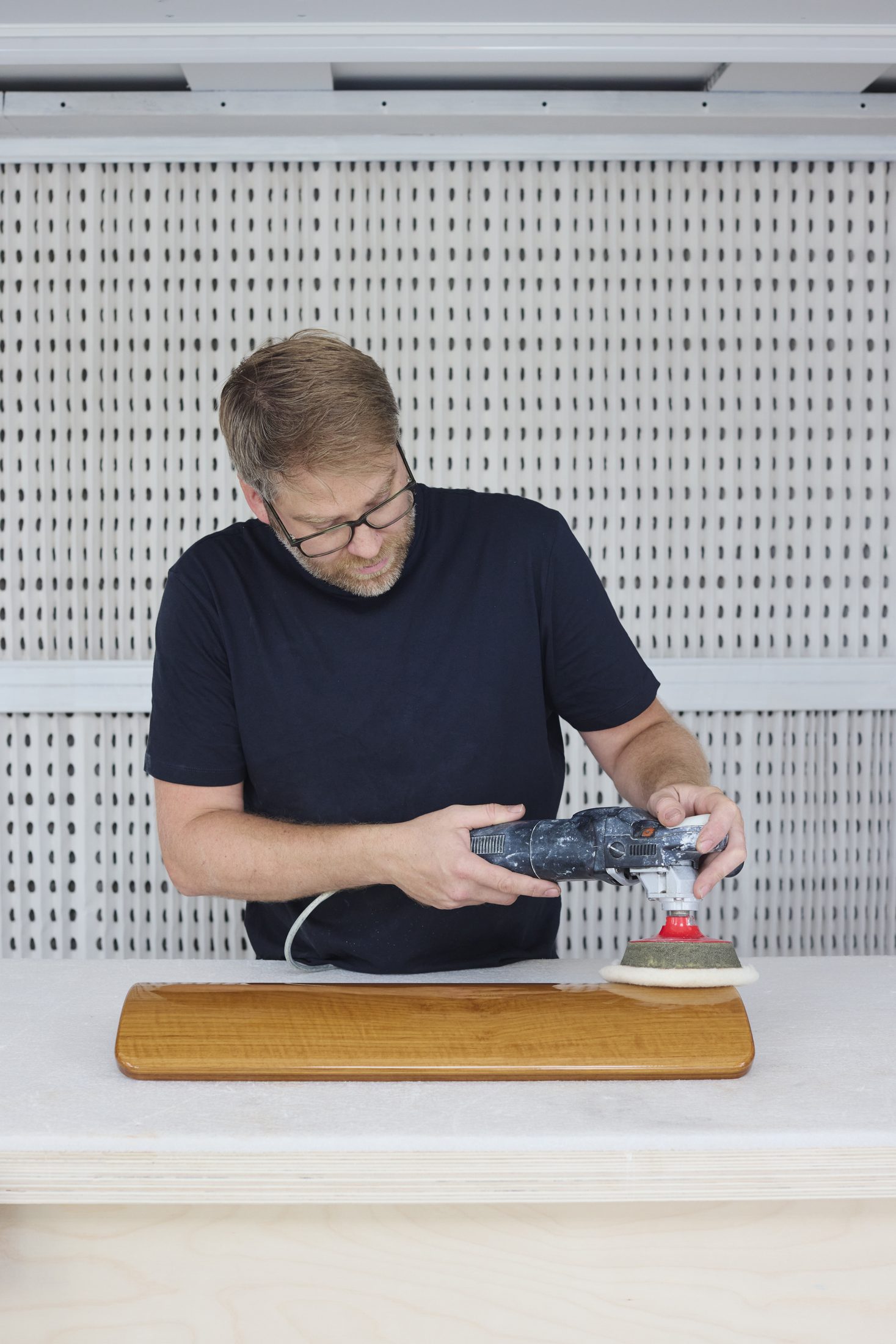 Hand-polishing a curved timber panel to a high gloss finish