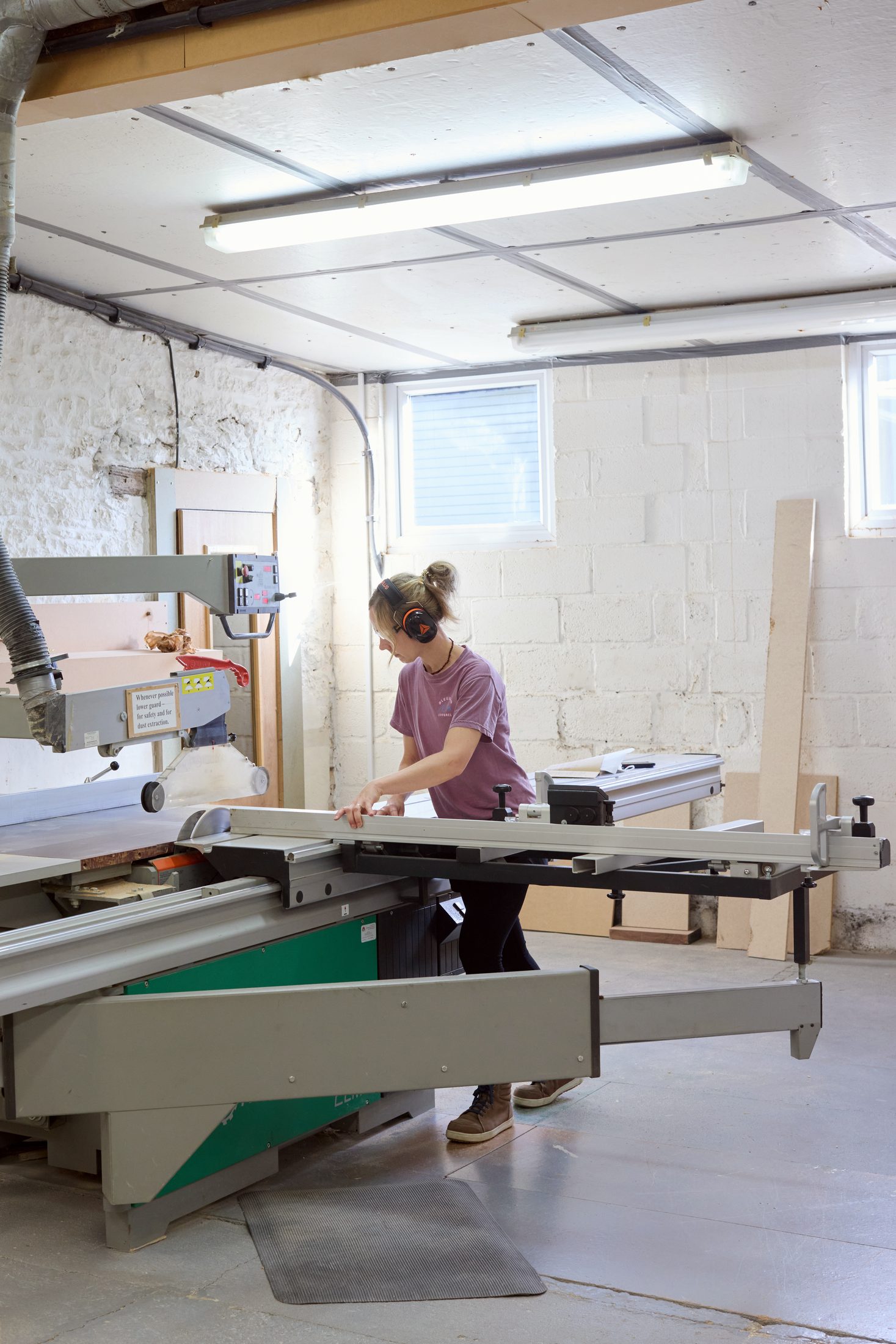 Cabinetmaker operating a panel saw in the workshop
